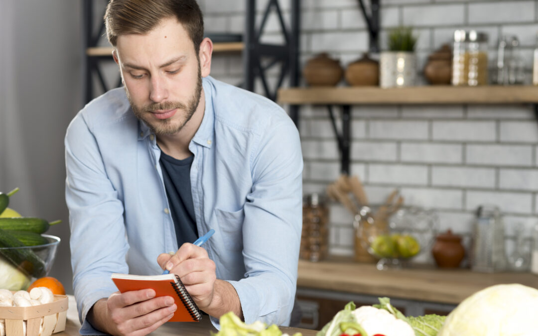 A busy man writing a weight loss recipe for his diary